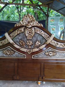 Ukiran kayu bermotif sulur pada kepala tempat tidur khas Jepara